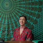 Photo by Caitlyn Anderson
Hypnotherapist Jenna Alexander smiles from behind her desk in her office, July 8.