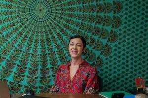 Photo by Caitlyn Anderson
Hypnotherapist Jenna Alexander smiles from behind her desk in her office, July 8.
