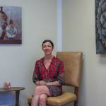 Hypnotherapist Jenna Alexander poses in a chair in her waiting room, July 8. (Photo by Caitlyn Anderson)