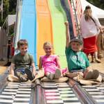 Kids race down the giant slide at the Whidbey Island Fair. (Photo by Caitlyn Anderson)