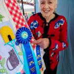 Photo by David Welton
Carole Wagner with her award-winning quilt at the Whidbey Island Fair.