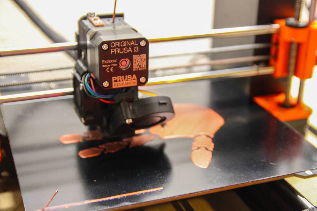 One of the Grays 17 3D printers slowly creates the layers that will form a hand. (Photo by Luisa Loi)