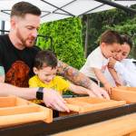 From left, Joe, Orion, Yessi and Jason Squish Dunegan sift sand in the sluice box to find hidden treasures. (Photo by Luisa Loi)