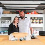 Kim and Chuck Boyer pose inside their mobile business, Whidbey Gemstone Finders, surrounded by bags of treasures. (Photo by Luisa Loi)