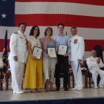 Commanding Officer Capt. Eric Hanks (left) and Rear Admiral Mark Sucato (right) pose with the Hanks family at Thursdays change of command ceremony. (Photo by Sam Fletcher)
