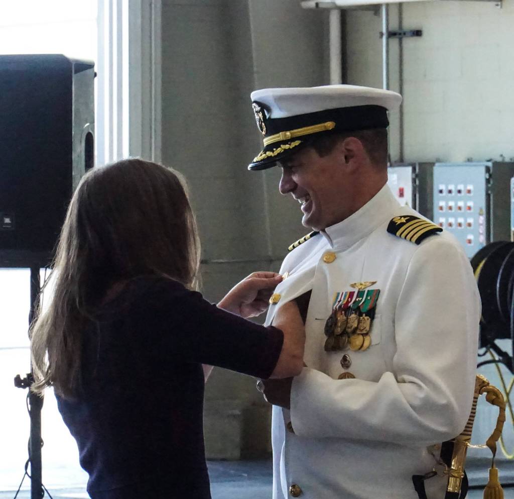 Photo by Sam Fletcher
Capt. Nathan Gammache, Naval Air Station Whidbey Islands new commanding officer, receives a pin from his wife, Julie, at the change of command ceremony on Thursday.