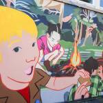 Photo by Luisa Loi
Vanessa Ciscos mural depicts a blond boy with a chochlear implant as he is about to eat a smore while his peers sit by a campfire.