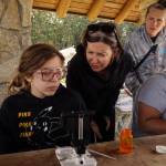 Bently Ashton-Beckley, an Atlantis STEAM student, and Kelly Zupich, Island County marine resources committee coordinator, identify plankton sampled via robot at Cornet Bay on Friday. (Photo by Sam Fletcher)