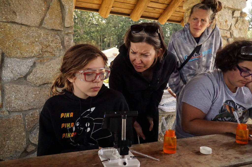 Bently Ashton-Beckley, an Atlantis STEAM student, and Kelly Zupich, Island County marine resources committee coordinator, identify plankton sampled via robot at Cornet Bay on Friday. (Photo by Sam Fletcher)