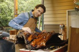 Glen Pearson of Clinton sands the epoxy coating he applied to a twisted and gnarled piece of maple. (Photo by Kira Erickson/South Whidbey Record)