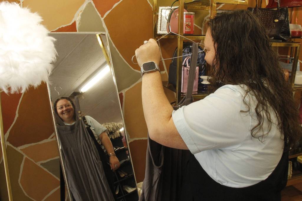 Photo by Kira Erickson/South Whidbey Record
Liz Smith holds up a jumpsuit, a bestselling item in Island Boutique.