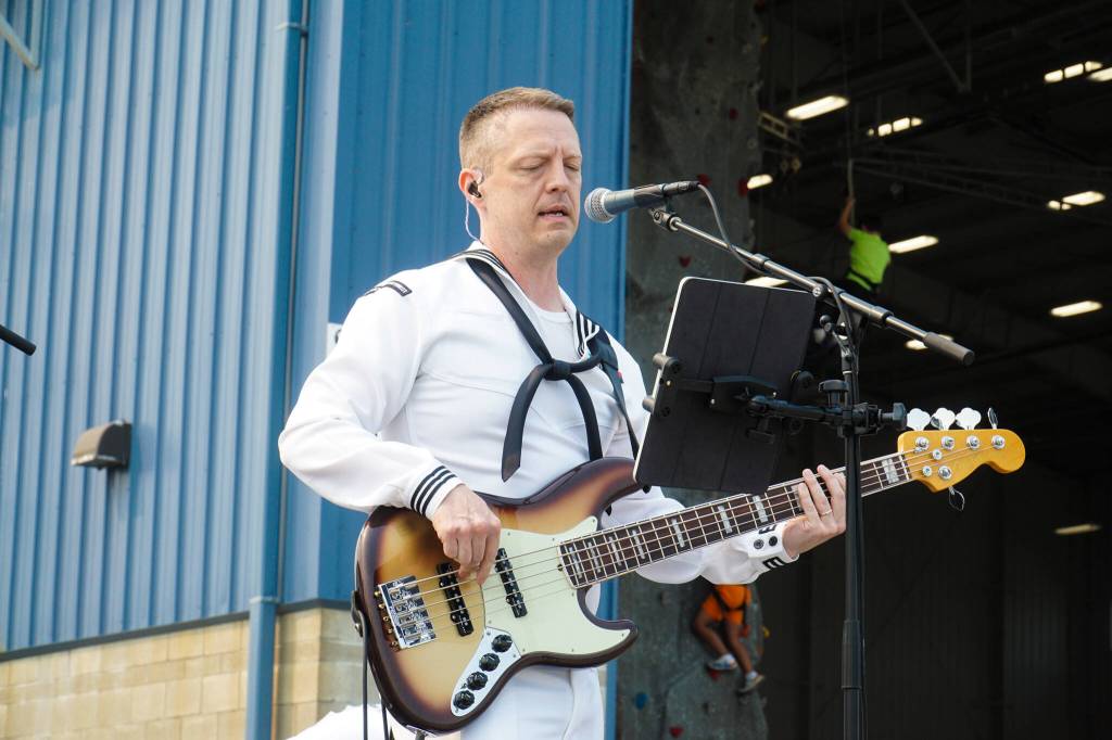MU3 Jeremy Sauer leads the Navy Band Northwest at Naval Air Station Whidbey Island on Saturday. (Photo by Sam Fletcher)