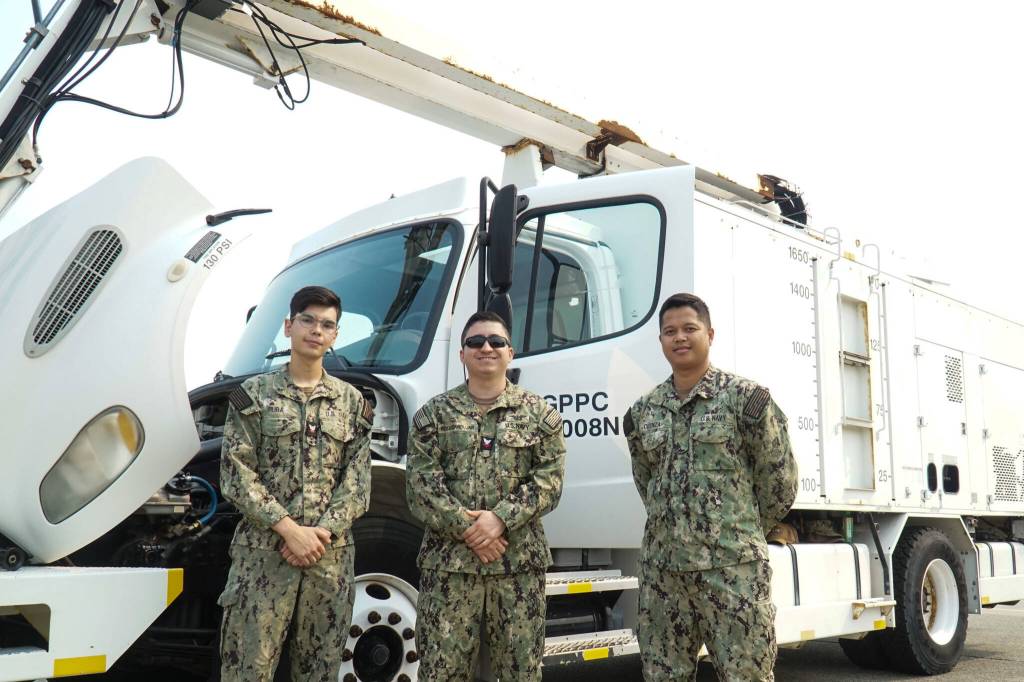 Left to right: AS3 Benjamin Ruba, AS2 Wilton Rosaedoadujar and Airman Nelmar Obaza pose at the Naval Air Station Whidbey Island open house on Saturday. (Photo by Sam Fletcher)