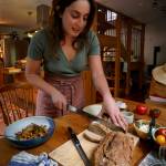 Renée Blair slices a freshly baked loaf of sourdough bread. (Photo by David Welton)