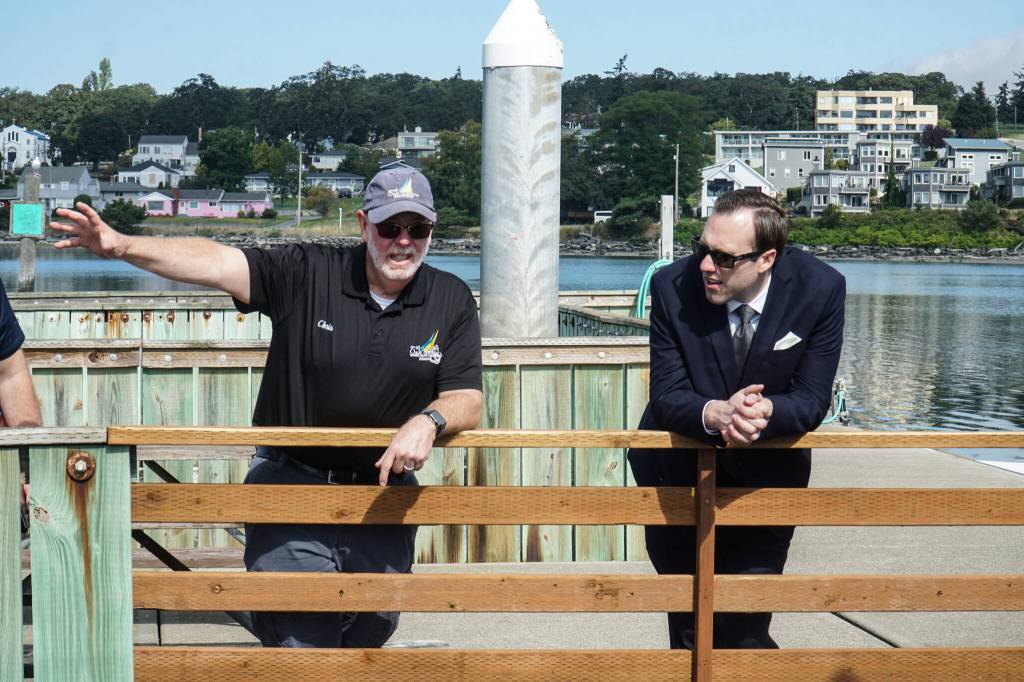 Harbor Master Chris Sublet (left) chats with Councilmember Bryan Stucky (right) over a recently repaired section of F Dock on Thursday morning. (Photo by Sam Fletcher)
