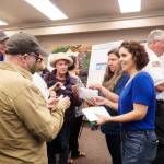 Mayor Pro Tem Tara Hizon (right) hands out stickers for Oak Harbor residents to cast their vote on the marinas future. (Photo by Sam Fletcher)