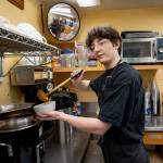 Brody Ehling ladles some creamy tomato basil soup in the kitchen of the South Whidbey Commons. (Photo by David Welton)