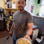 Davin McCullough serves a scone. (Photo by David Welton)