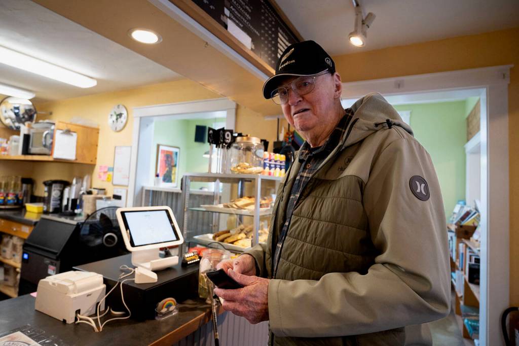 Tom Campbell steps up to the register to donate to the South Whidbey Commons fundraiser. (Photo by David Welton)