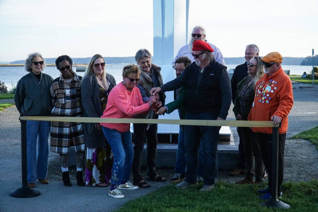 Members of the City of Oak Harbor and Sculpture Northwest cut the ribbon for the Angel de Creatividad, Oak Harbors new 40-foot sculpture at Flintstone Park on Thursday. (Photo by Sam Fletcher)