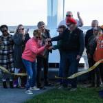 Members of the City of Oak Harbor and Sculpture Northwest cut the ribbon for the Angel de Creatividad, Oak Harbors new 40-foot sculpture at Flintstone Park on Thursday. (Photo by Sam Fletcher)