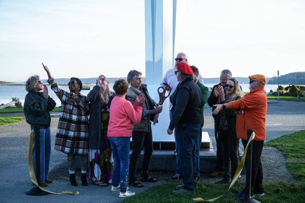 Members of the City of Oak Harbor and Sculpture Northwest cut the ribbon for the Angel de Creatividad, Oak Harbors new 40-foot sculpture at Flintstone Park on Thursday. (Photo by Sam Fletcher)