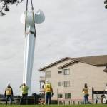 Ram Construction staff hoist the horizontal Angel De Creatividad sculpture upright on Wednesday. (Photo by Sam Fletcher)