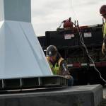 Ram Construction staff hoist the horizontal Angel De Creatividad sculpture upright on Wednesday. (Photo by Sam Fletcher)
Ram Construction staff prepare to mount the Angel De Creatividad sculpture on its platform on Wednesday. (Photo by Sam Fletcher)