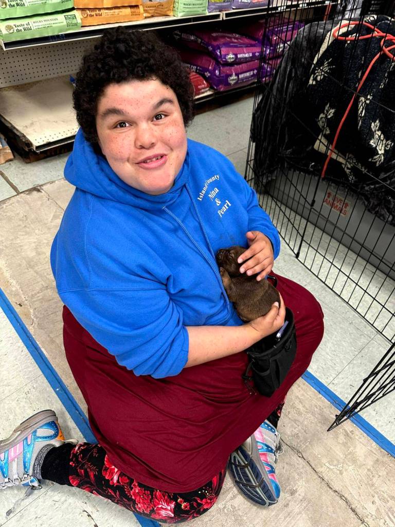 Nina Driscoll holds a puppy at Critters Co. Pet Center Rescue in Clinton. (Photo provided)