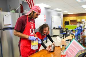 (Photo by Luisa Loi)Transition Specialist Erin Straub assists Nehemiah Myles in making an egg nog latte for a reporter.