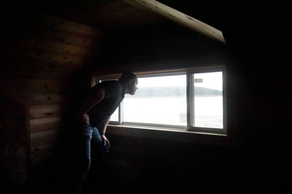 Reese Bliek, owner of Coppertop Construction, looks out the loft window of a Pioneer Way home built in 1925. (Photo by Sam Fletcher)