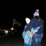 Amie Welden holds her daughter, Kailee, before the procession of Lt. Serena Dug Wileman, one of the two aviators lost in the Oct. 15 EA-18G Growler crash during routine training near Mount Rainier, as she returned home from Dover Air Force Base on Monday. (Photo by Sam Fletcher)