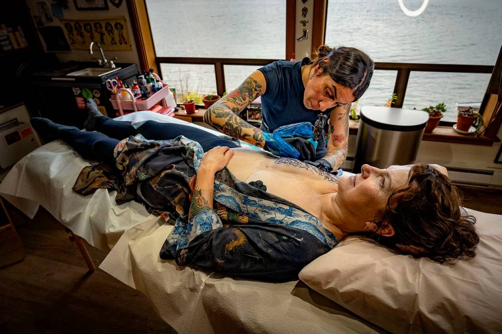 (Photos by David Welton)
Renata Vignati tattoos a starfish design onto cancer survivor Teresa Forsyths reconstructed breast. Tattoos that help cover up mastectomy scars are an empowering way for women to reclaim their bodies.
