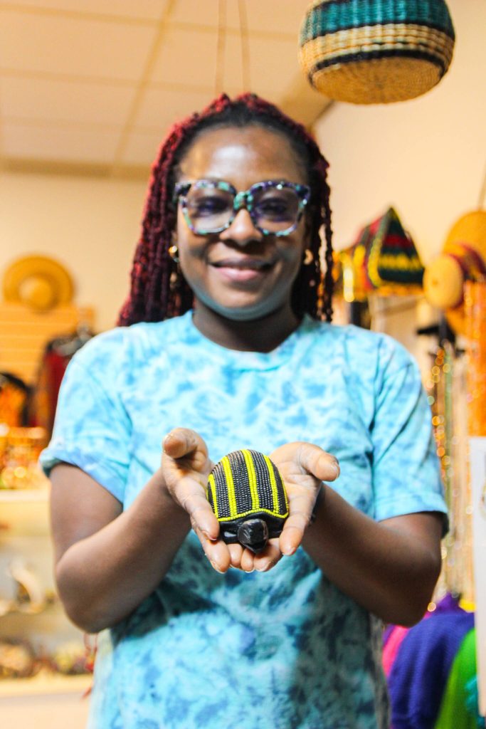 (Photo by Luisa Loi)
Dei holds a beaded wooden turtle.