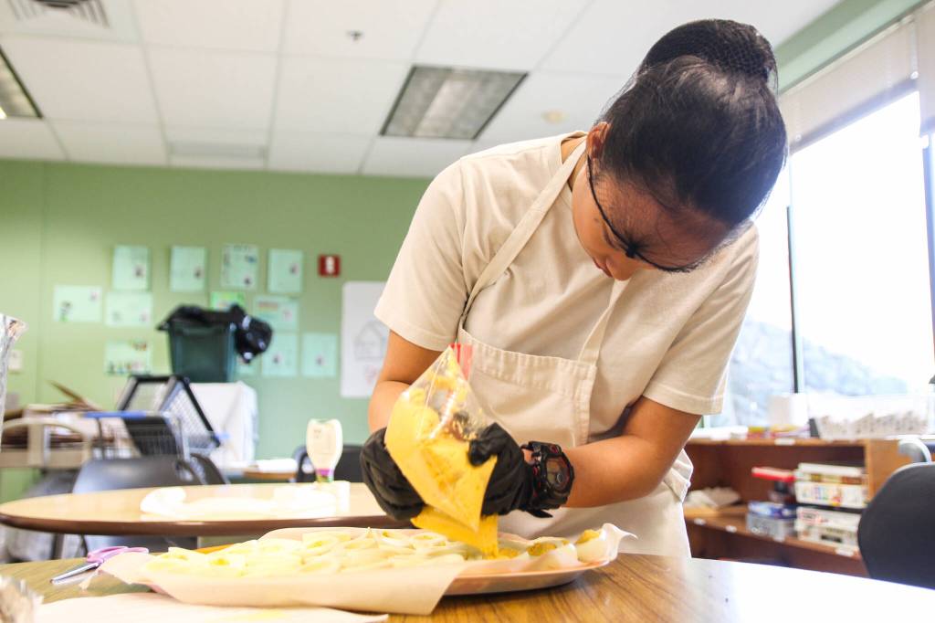 (Photo by Luisa Loi)
Zoe Castillo fills the deviled eggs.