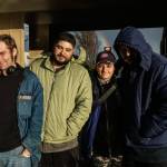 Nick Coloso (left), Phoenix Welch (middle-right) and other patrons of the SPIN Cafe await meals on Friday. (Photo by Sam Fletcher)