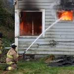 Firefighters from Oak Harbor, North Whidbey, South Whidbey and Naval Air Station Whidbey Island conduct live burn training in Oak Harbor last week. (Photo by John Fisken)