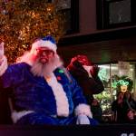 Santa takes a ride on a fire truck during the festive Oak Harbor event. In addition, all kinds of other Christmas characters marched through the towns, waving, dancing and throwing candy for the many onlookers. (Photo by Sam Fletcher)