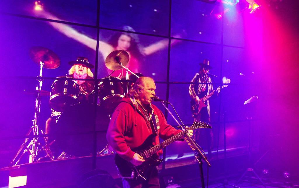 (Photo by Luisa Loi)
Don Hanson performs Alone Again Or by Love, as a woman in a red dress wildly dances in the background.