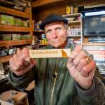 (Photo by David Welton)
John Schmidt has many amusing elements that can be attached to his birdhouses, including this No Cats Allowed sign.