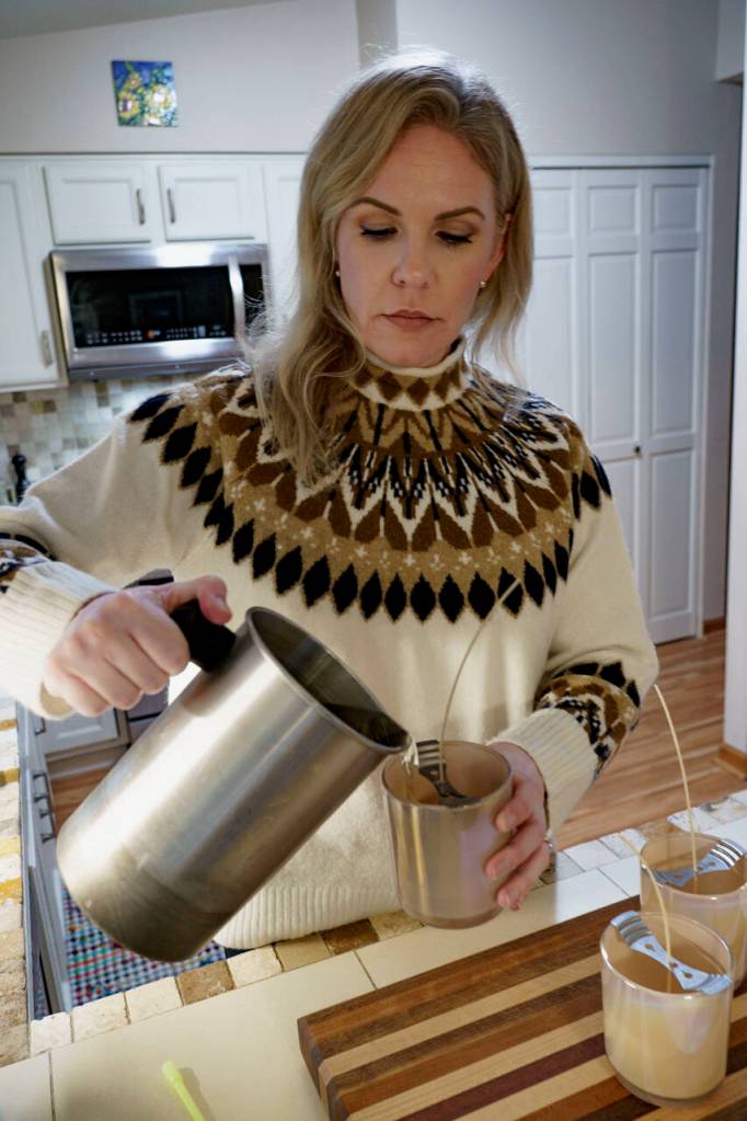 Photo by David Welton
Lindsay Kelley pours hot wax, infused with the scent of Pear Prosecco, into candle molds.