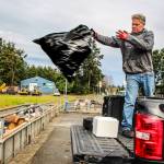 (Photo by Ian Tiessen)
Jeff Frey throws a trash bag into the dump at the Island County Solid Waste Complex.