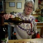 (Photo by David Welton)
Greenbank Farm Wine Shop employee Cathy Kind pours some loganberry wine.