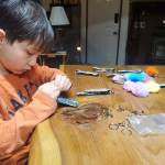 Jeremiah Lucian works on some keychains.