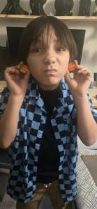 Photo provided
Jeremiah Lucian shows off some earrings he made in the shape of basketballs.