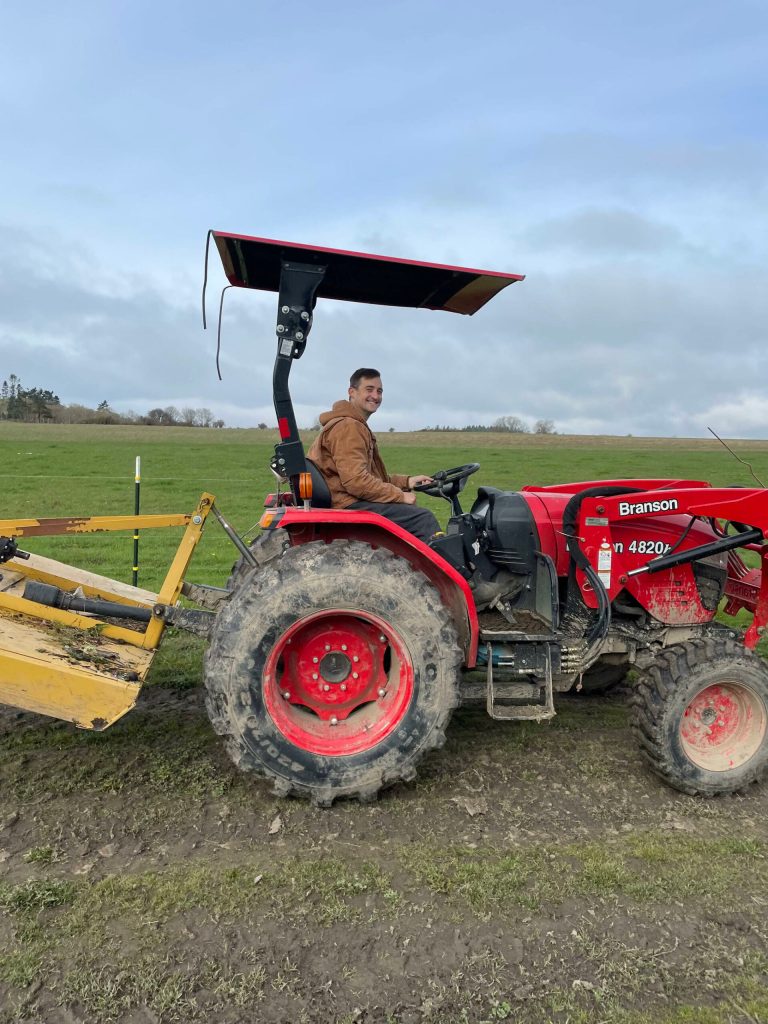 Bart Crowder, president of the Farm Bureau, drives a tractor on the 1902 Ranch in Coupeville. (Photo provided)