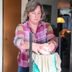 After a few hours of stirring and heating the milk into curds, Diana Miller prepares the cheese-to-be for the press.
