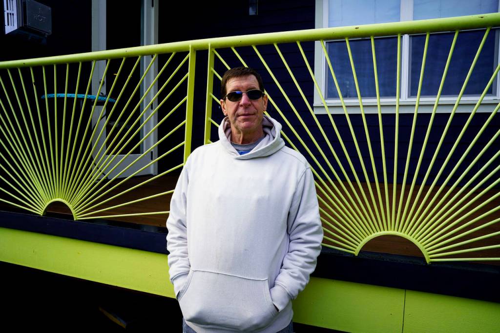 Photo by David Welton
Jim Bernacki stands before the bright green deck rail he welded for his own home on South Whidbey.
