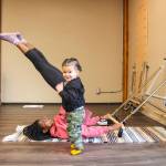 Photo by Luisa Loi
Shelby Novak stretches with the help of a spring board while her son Glenn provides emotional support.