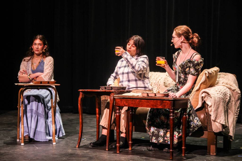 (Photo by Luisa Loi) At left, Adriana Froman plays a teenager who begs her parents (Abby Lockard and Hailie Hennessey) to let her go to the Woodstock music festival.
